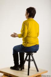 Sitting reference of yellow sweater blue jeans Gwendolyn